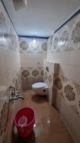 a bathroom with a toilet and a bucket in it at Sandiago Villa 2 Bhk House - Only Bachelors Adults in Ooty