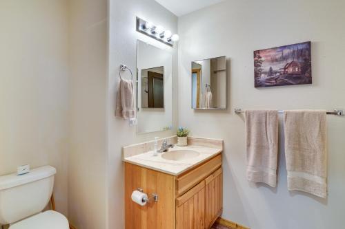 a bathroom with a sink and a toilet and a mirror at Spacious Beaver Getaway Near Eagle Point Resort! in Beaver