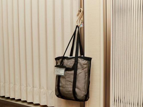 a bag hanging on the side of a door at Grand Cabin Hotel Naha Oroku - Vacation STAY 46864v in Naha