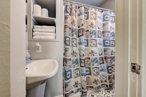 a bathroom with a sink and a shower curtain at Putnam Pad II - City card 4 local biz discount in Oklahoma City