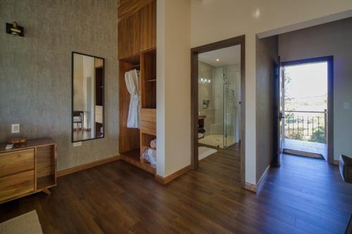 a bathroom with a mirror and a walk in shower at Emmalu Hotel Boutique in San Marcos