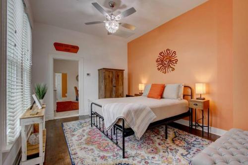 a bedroom with a bed and a ceiling fan at Clementine Bungalow Downtown Hot Springs in Hot Springs