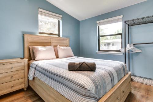 a bedroom with a large bed with blue walls at St Cloud Vacation Rental - Walk to Lakefront Park! in Saint Cloud
