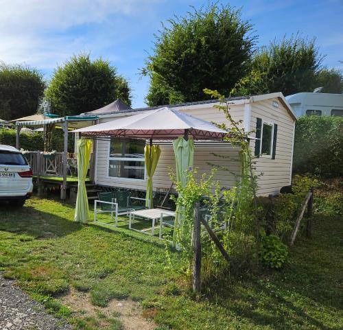 une caravane blanche avec une table et une tente dans l'établissement Magnifique Mobil home Lac D'Aiguebelette, à Novalaise