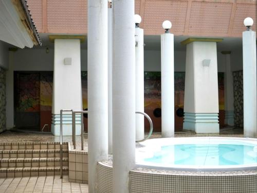 a hot tub in the middle of a building with columns at Bokkai Onsen Seaside Villa Bokkai - Vacation STAY 69010v in Shika