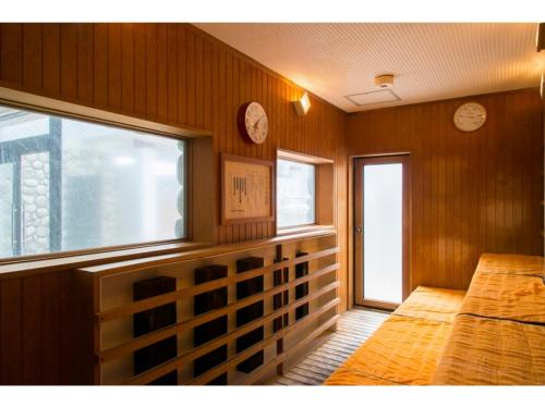 a room with two beds and two clocks on the wall at Bokkai Onsen Seaside Villa Bokkai - Vacation STAY 69023v in Shika