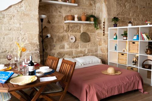 a bedroom with a table and a bed in a room at Casa Terolì in Bari
