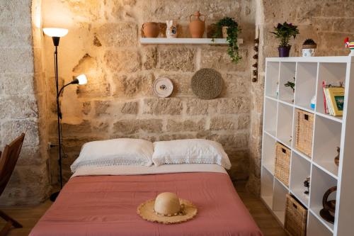 a bedroom with a bed with a hat on it at Casa Terolì in Bari