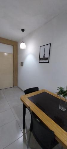 a dining room with a table and a picture on the wall at Departamento Citrino in Godoy Cruz