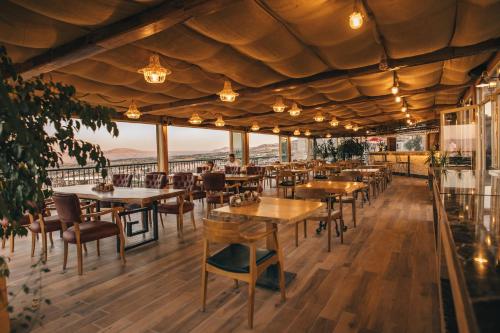 a restaurant with tables and chairs and a view at Hu of Cappadocia - Special Class in Uchisar
