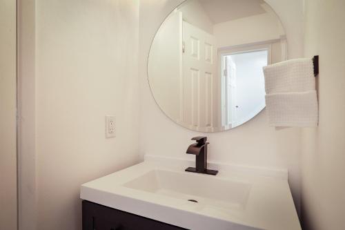 a bathroom with a sink and a mirror at La Mer Suites in Fort Lauderdale