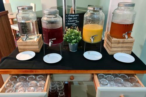 a table with two bottles of juice and plates and drinks at Park hall Hotel & Spa Lancashire, a member of Radisson Individuals in Eccleston