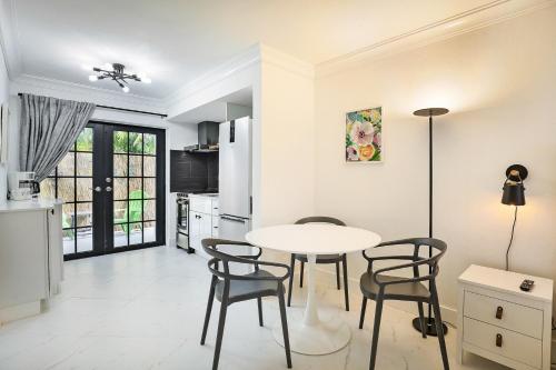 a kitchen and dining room with a table and chairs at La Mer Suites in Fort Lauderdale