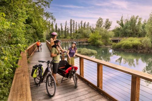 a group of people standing on a bridge with their bikes at My Comfort in Treviso
