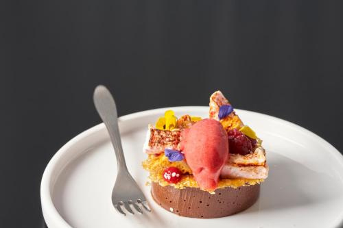 a piece of cake on a plate with a fork at Sandy Cove Hotel in Ilfracombe