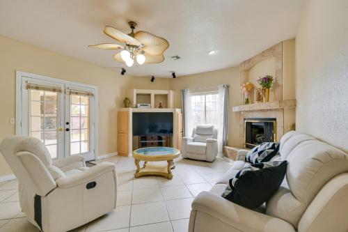 a living room with white furniture and a fireplace at Luxe Yuma Home with Private Pool! in Yuma
