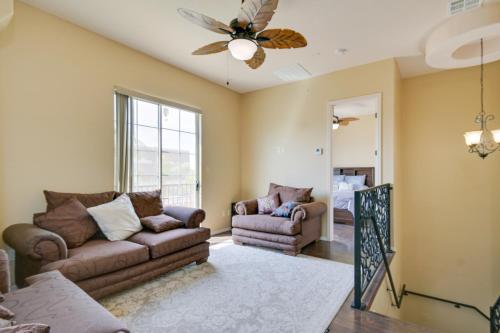 a living room with two couches and a ceiling fan at Luxe Yuma Home with Private Pool! in Yuma