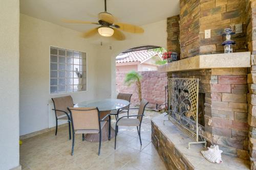 a dining room with a brick fireplace and a table and chairs at Luxe Yuma Home with Private Pool! in Yuma