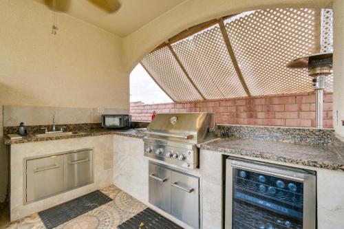 a kitchen with a stove and a sink at Luxe Yuma Home with Private Pool! in Yuma
