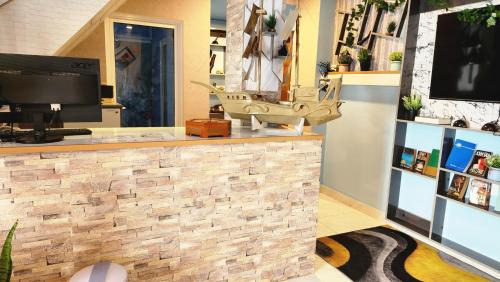 a lobby of a store with a stone wall at Isle inn in Fuvahmulah