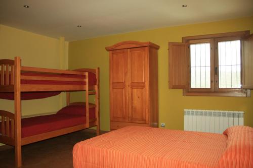 a bedroom with a bunk bed and a cabinet at La Casa Nueva in Nieva de Cameros