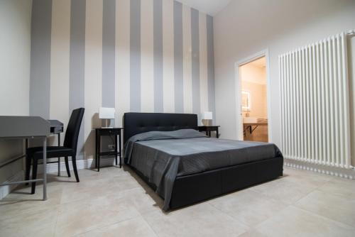 a bedroom with a bed and a table and chairs at La Finestra Sul Vulcano in Roccamonfina