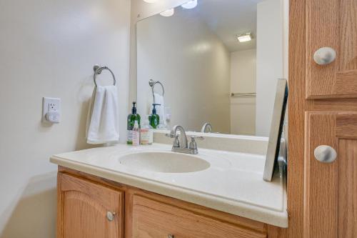a bathroom with a sink and a mirror at Charming Chapel Hill Townhome Near University! in Chapel Hill