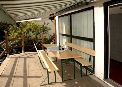 a wooden table and bench on a patio at Beide Bumpkes in Weitramsdorf