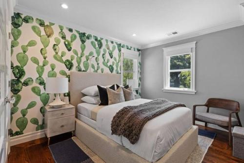 a bedroom with a bed with a green accent wall at Walkable Luxury Designer Home in Burlingame