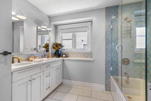 a bathroom with two sinks and a shower at Walkable Luxury Designer Home in Burlingame