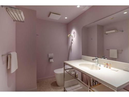 La salle de bains est pourvue d'un lavabo, de toilettes et d'un miroir. dans l'établissement THE BOLY OSAKA - Vacation STAY 52787v, à Osaka