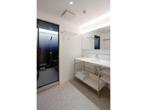 a bathroom with a sink and a mirror at THE BOLY OSAKA - Vacation STAY 52036v in Osaka