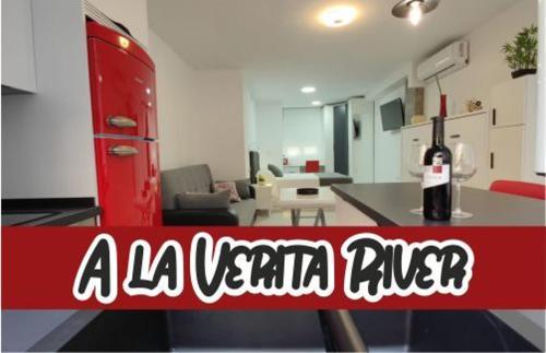 a bottle of wine sitting on a table in a living room at Loft A la verita River,PARKING PRIVADO GRATIS in Córdoba