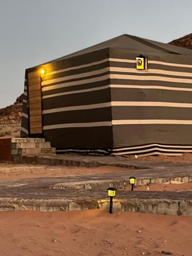 a building with two parking meters in front of it at wadi rum camp stars & jeep tour in Wadi Rum