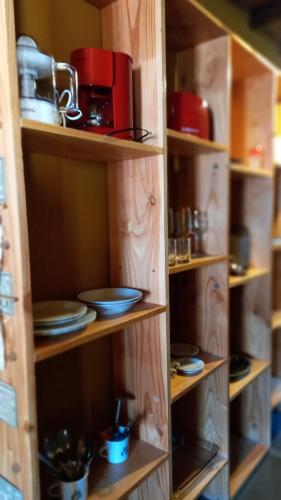 a wooden pantry with wooden shelves filled with dishes at kukachalten in El Chalten
