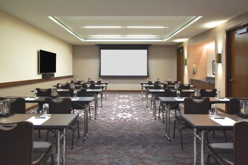 a conference room with tables and a projection screen at Loews Chicago Hotel in Chicago
