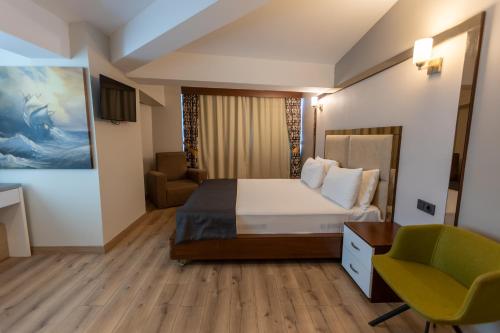 a hotel room with a bed and a chair at Asia Business Suites in Istanbul