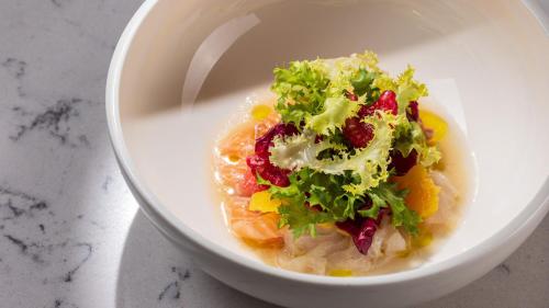 a white bowl of food with vegetables and lettuce at InterContinental - Ljubljana by IHG in Ljubljana