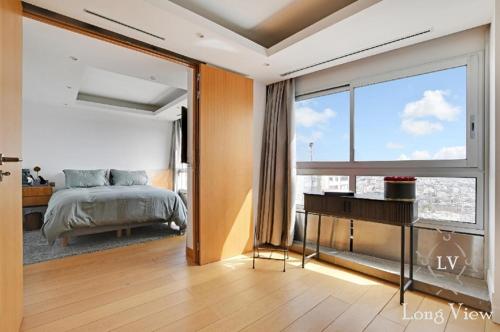 a bedroom with a bed and a large window at Sky Terrace Eiffel Tower area in Paris