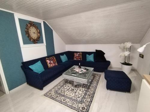 a living room with a couch and a table at Apartmani Jozić in Garešnica