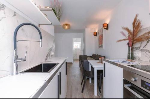 a kitchen with a sink and a counter top at Moderne studio in Nieuwpoort