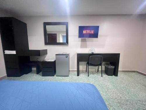 an office with a desk and a chair and a mirror at Hotel Casa-Noria Acapulco in Acapulco