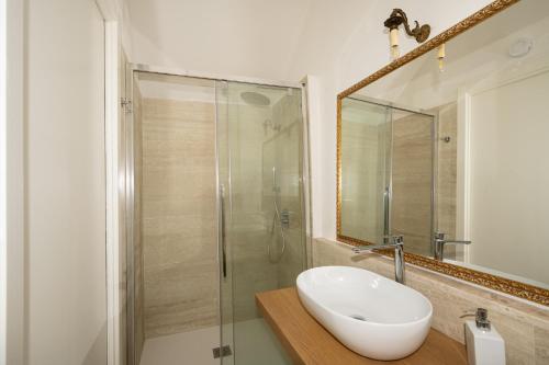 a bathroom with a sink and a glass shower at Sa ia Suite 2 in Cagliari