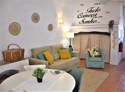a living room with a couch and a table at Casa da Chaminé - Refúgio com Charme Alentejano in Amieira