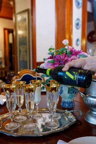 a person pouring a glass of wine on a table at Hotel Bosnali in Adana