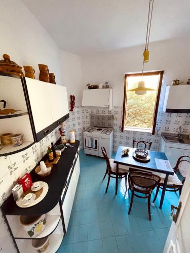 a kitchen with a table and chairs and a dining room at Villa Rosanna in Massa Lubrense
