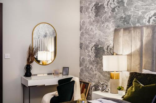 a living room with a mirror and a couch at The WaterHouse Avenue by Kandara 5 Star City Home in Maidstone in Maidstone