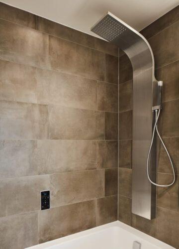 a shower with a shower head in a bathroom at The WaterHouse Avenue by Kandara 5 Star City Home in Maidstone in Maidstone
