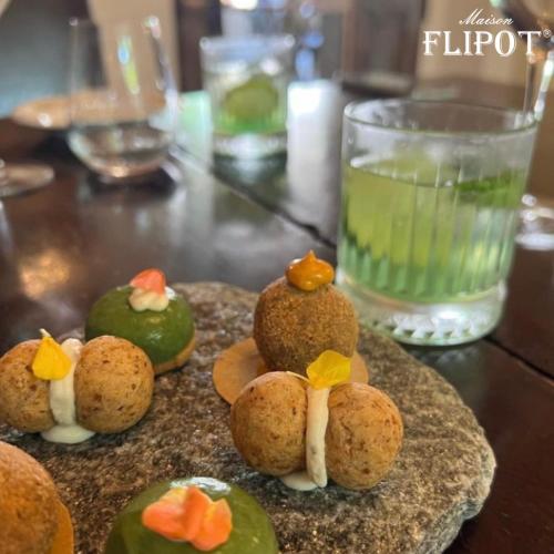 a plate of food on a table with a drink at Maison Flipot in Torre Pellice