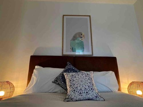 a bedroom with a bed with a picture on the wall at Nest Apartments on Rose Lane in Melbourne